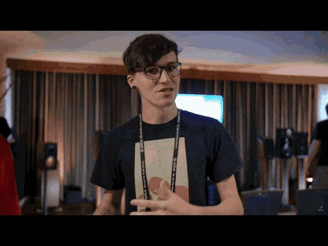 a man wearing glasses and a lanyard that says yamaha on it