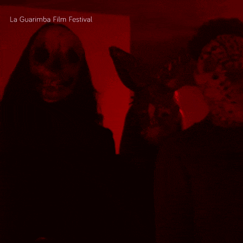 a poster for the la guarimba film festival shows a man and a woman wearing masks