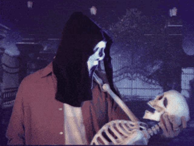 a skeleton is kissing a man with a hood on