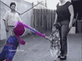 a pixelated image of a woman holding a child 's hand while holding a pink piñata