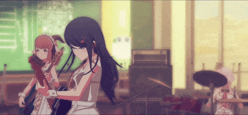 a girl with long black hair is holding a guitar in a room