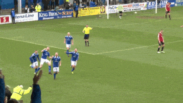 a group of soccer players wearing blue and white jerseys with the word everton on the front