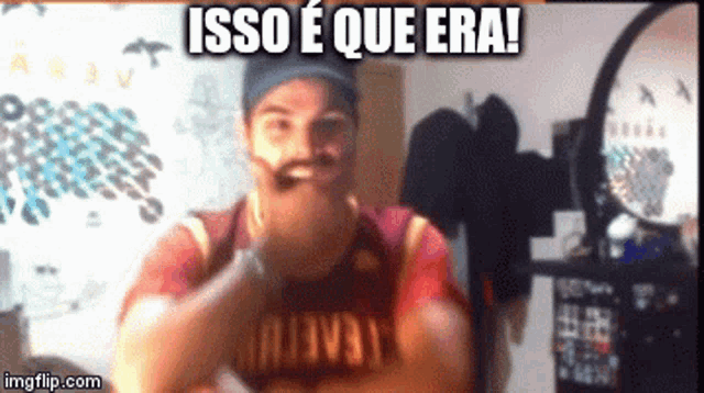 a man with a beard and mustache is wearing a red shirt that says isso e que era