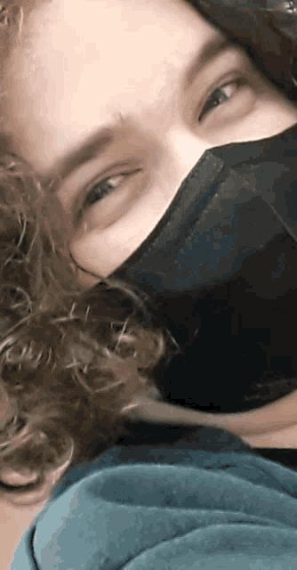 a close up of a person wearing a mask