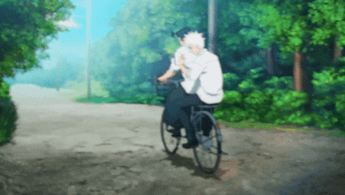 a man is riding a bike with a child on his back
