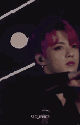 a close up of a person with pink hair .