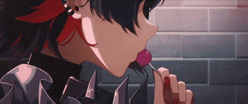 a girl with red hair is licking a lollipop