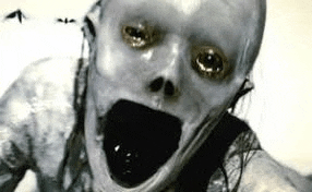 a black and white photo of a scary zombie with a skull on his face .