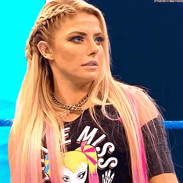 a woman with blonde hair is wearing a black shirt that says miss
