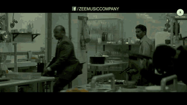 a black and white photo of people in a kitchen with the words zeemusiccompany on the top