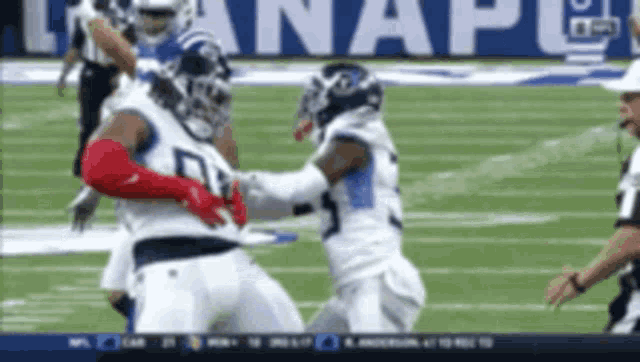 a football game is being played in front of a banner that says nfl on it