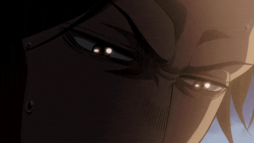 a close up of a man 's face with his eyes glowing in the dark
