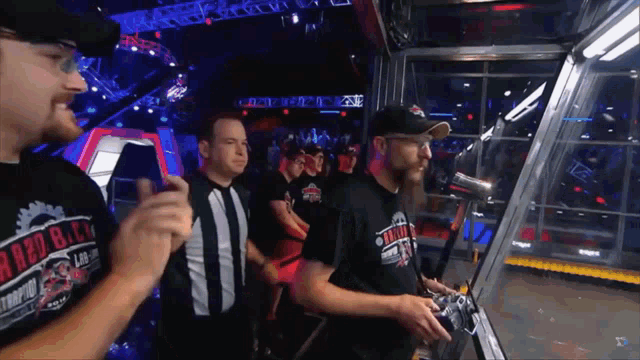 a group of men are playing a video game and one of them is wearing a shirt that says ' red bay ' on it