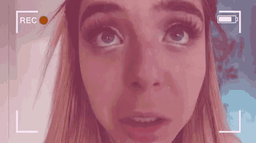 a close up of a woman 's face with a red rec button