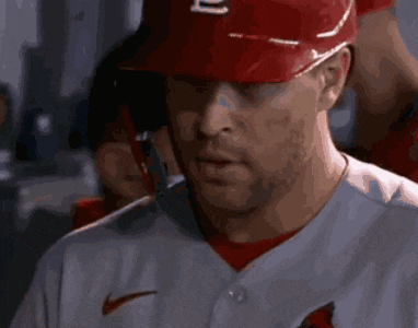 a baseball player wearing a red hat with a letter l on it