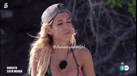 a woman wearing a hat and a bikini is on a tv screen with the number 5 on it
