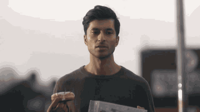 a man holding a donut and a piece of paper in front of a kfc
