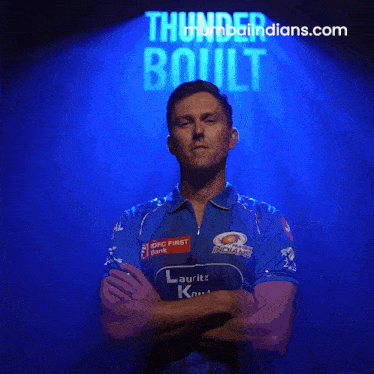 a man with his arms crossed in front of a sign that says " thunder boult "
