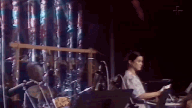 a woman in a wheelchair is playing a keyboard on a stage .