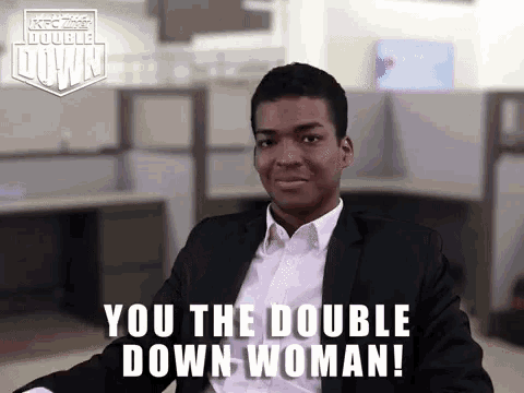 a man in a suit and white shirt is sitting in an office and says you the double down woman