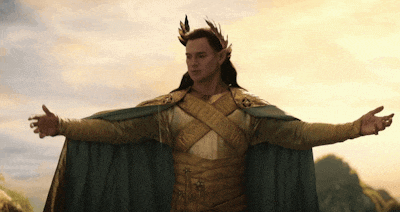 a man in a costume with a laurel wreath on his head stands with his arms outstretched
