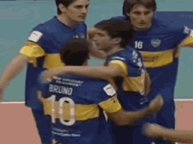 a group of soccer players are hugging and one of them has the number 10 on his back