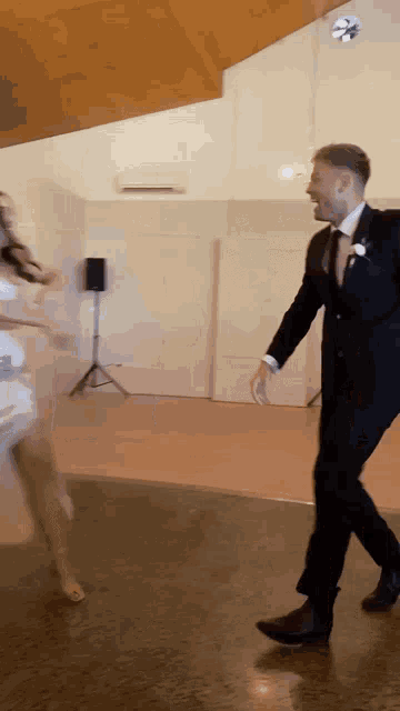 a man in a suit is dancing with a woman