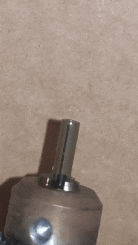 a close up of a metal object with a red light on it