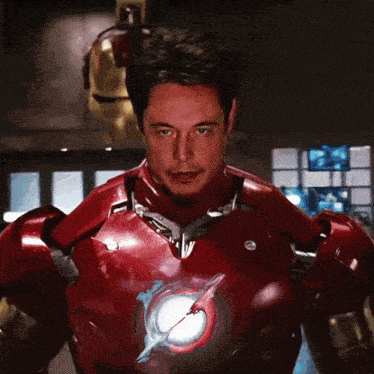 a man in a red iron man suit stands in front of a wall