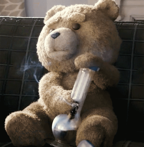 a teddy bear sitting on a couch smoking a bong with smoke coming out of it