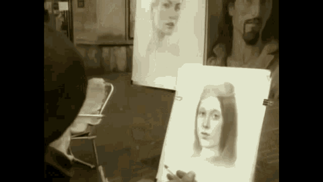 a man is drawing a portrait of a woman