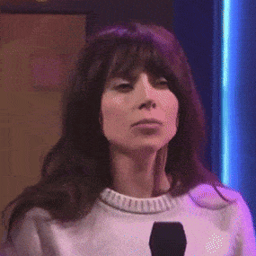 a woman wearing a white sweater and a black microphone