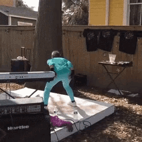 a person is standing on a stage in front of a hartke speaker