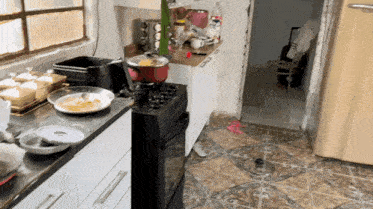 a kitchen with a stove and a pot of food on the counter