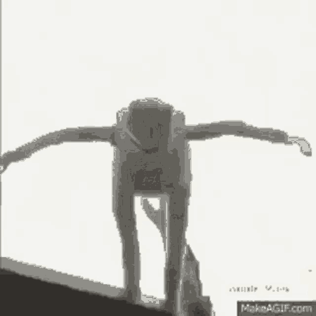 a black and white photo of a person standing in front of a door in a room .