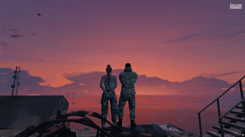 a man and a woman in military uniforms are standing on a rock overlooking the ocean