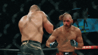 two men are boxing in a ring with a sign that says lead on it