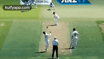 a group of cricket players are playing a game of cricket .