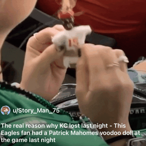a person holding a patrick mahomes voodoo doll