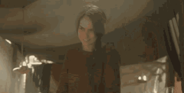 a woman in a brown sweater is smiling in a tent .