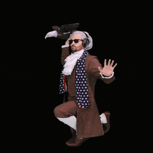 a man in a historical costume is holding an eagle on his shoulder