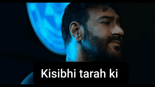 a man with a beard is standing in front of a blue background with the words kisibi tarah ki