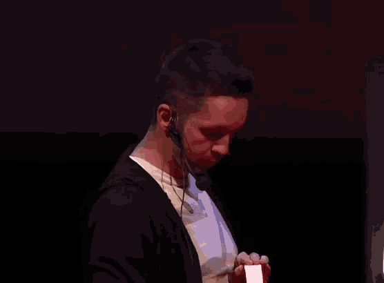 a man wearing a headset and a white shirt with the letter a on it
