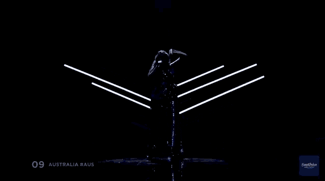 a silhouette of a woman standing on a stage with the number 09 on the bottom