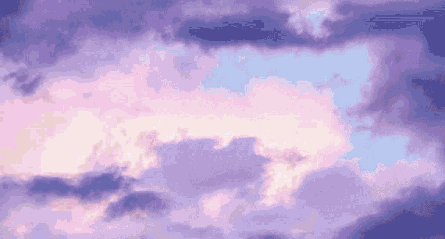 purple and pink clouds are moving in the sky