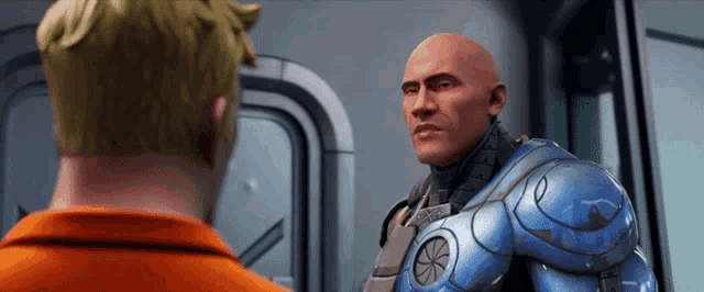 a bald man in a blue suit is standing next to another bald man in an orange shirt .