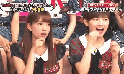 two girls are sitting next to each other and one has a tag that says 1st