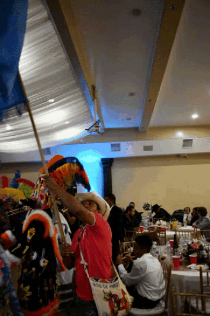 a man in a cowboy hat is holding a flag that says mexico on it