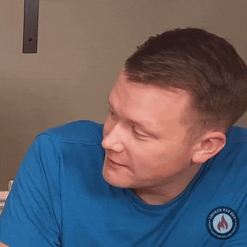 a man is wearing a blue shirt that says smoked red hot