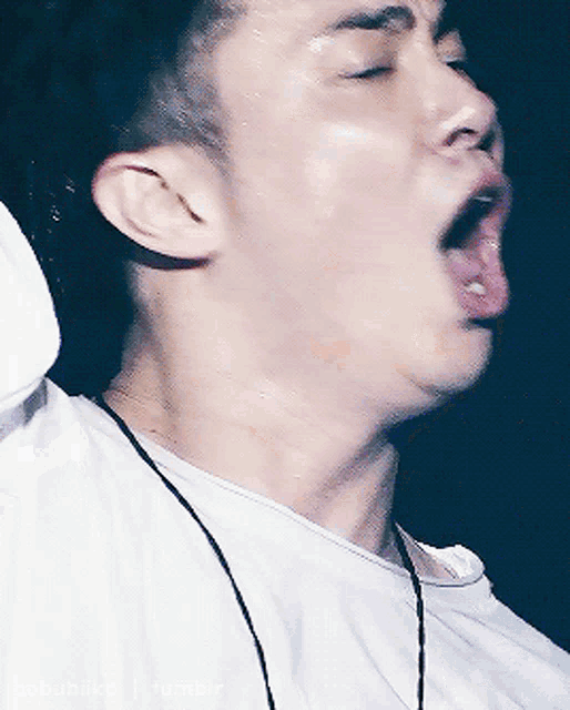 a close up of a man 's face with his tongue hanging out